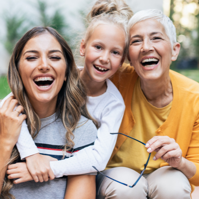 Three generations of women sitting together smiling